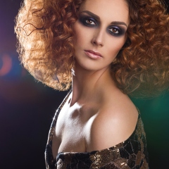 Studio Portrait Of Beutiful White Woman With Brown Afro Hair.