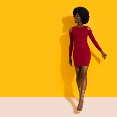 Happy Young Black Woman In Red Mini Dress And High Heels Is Walking Towards Camera And Looking Away