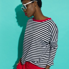 Cool black woman in striped blouse and sunglasses.