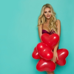 Beautiful Woman In Purple Lingerie Is Posing With Red Heart Shaped Balloons